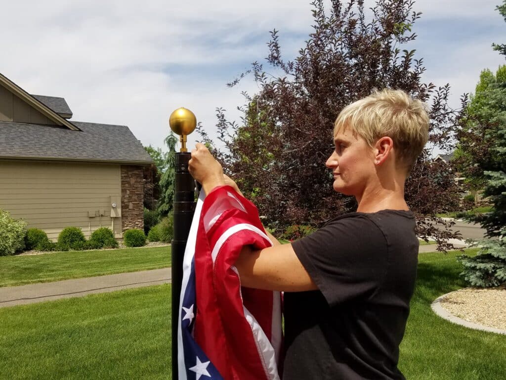 Woman Attaching American Flag To Telescoping Flagpole Made in USA