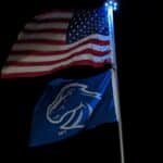 The United States Flag and Blue Mustang Flag lit by a Titan Solar Light.